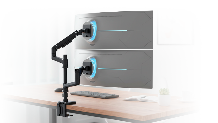 A modern office features a large curved monitor displaying a galaxy, with a keyboard, mouse, laptop, and plant on a wooden desk, surrounded by neutral-toned furniture and wall art.