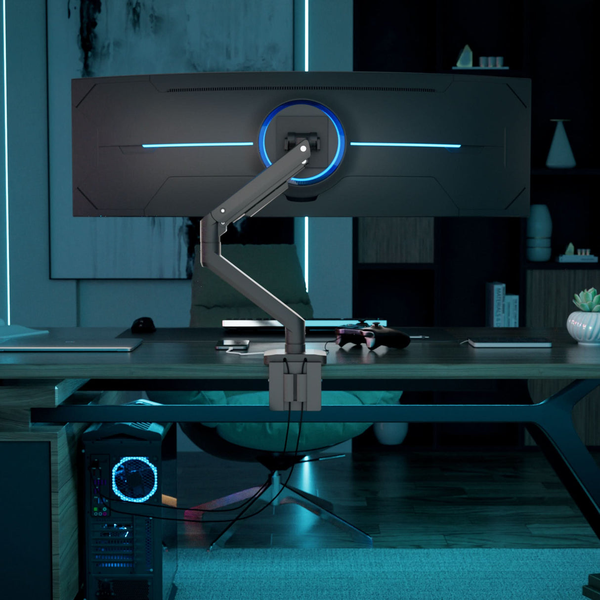 Heavy-Duty Monitor Mount with Gas Spring Arm A Mount-It! Heavy-Duty Monitor Mount with Gas Spring Arm holds a wide curved monitor above a modern desk in a dimly lit gaming setup, featuring blue accent lighting, tidy cables, shelves in the background, and a gaming PC on the floor.