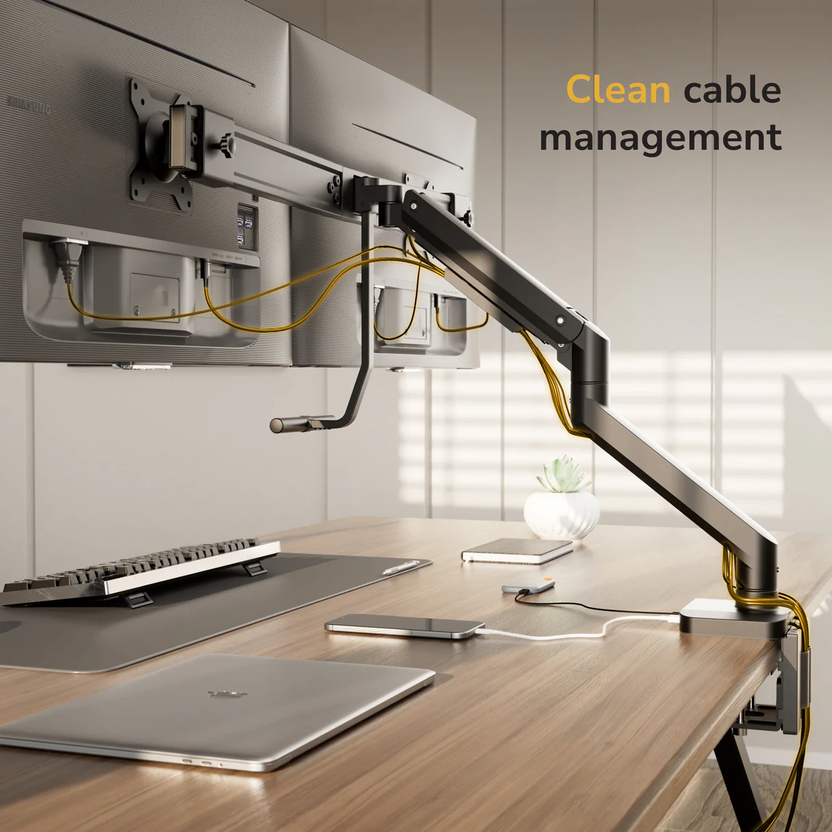 The Mount-It! Dual Monitor Mount with Gas Spring Arm and Crossbar displays a modern setup, featuring yellow cables neatly managed in the top right corner. Multiple devices are organized on the wooden desk.