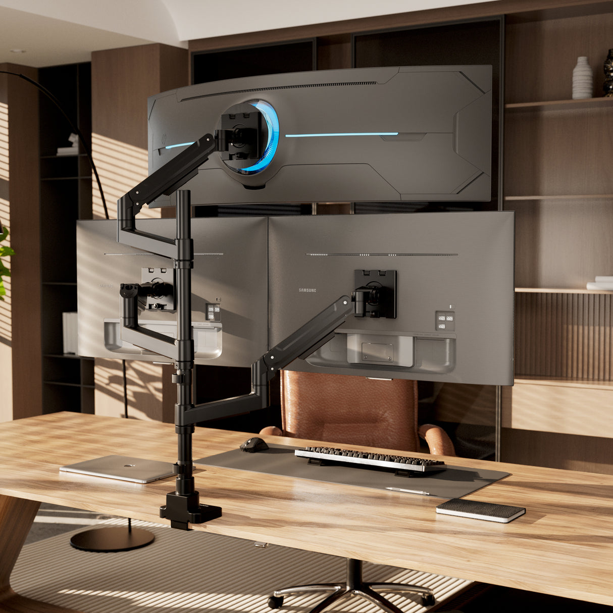 A modern office desk features the Mount-It! Heavy-Duty Triple Monitor Mount with adjustable gas spring arms, a keyboard, mouse, and a brown leather chair. Stylish wooden shelves and cabinets offer storage in the background.