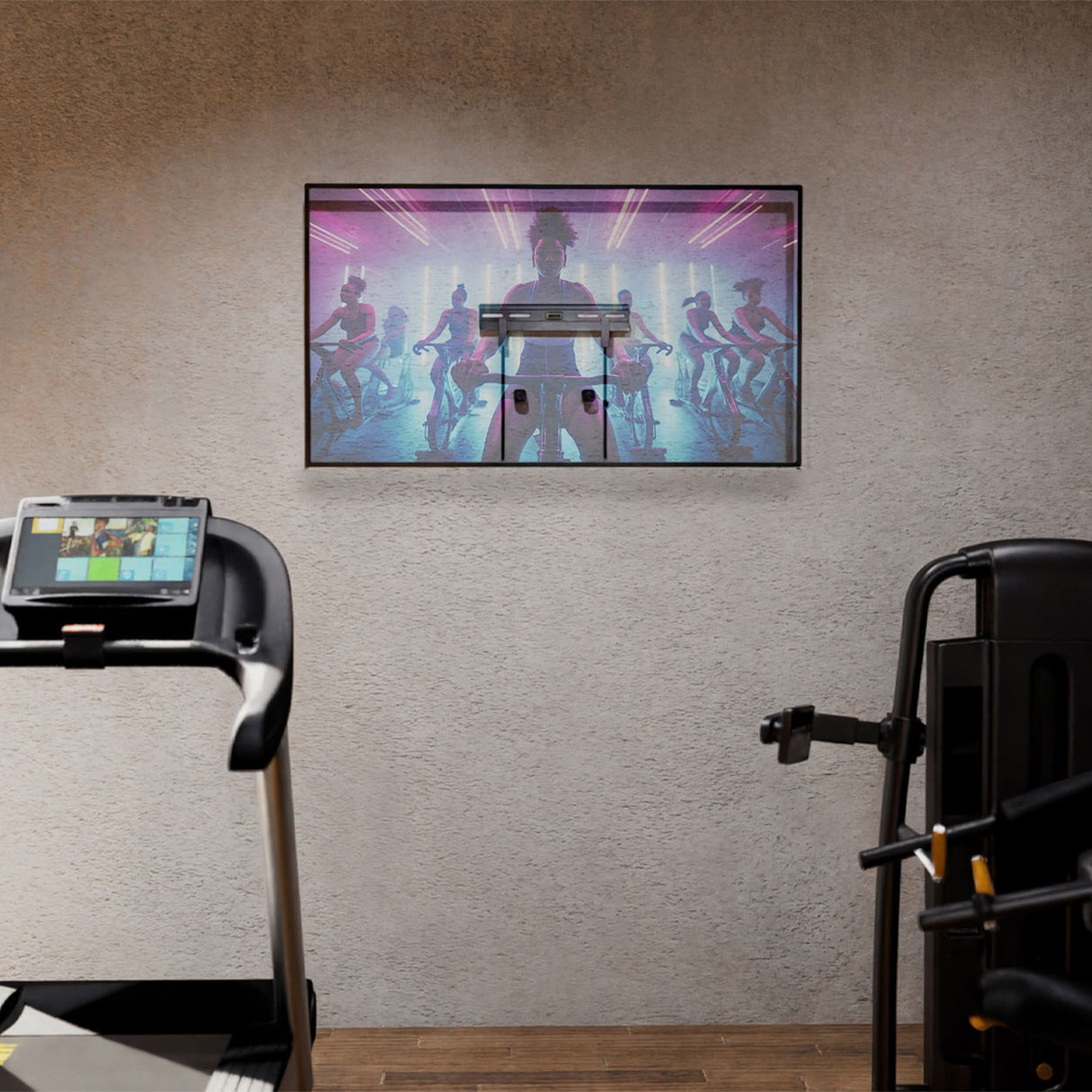 No Stud TV Wall Mount for TVs 23" - 65" No Stud TV Wall Mount for TVs 23" - 65" installed on a textured wall in a home gym setting, holding a flat screen TV streaming a fitness class, showcasing its low-profile design, clean mounting without visible studs or damage, and suitability for spaces like bedrooms, apartments, or offices where easy, damage-free installation is key.