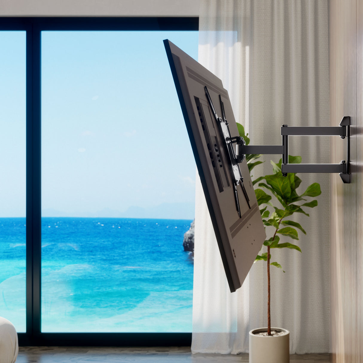 Full Motion TV Wall Mount A flat-screen TV is mounted on the Mount-It! Full Motion TV Wall Mount, angled toward a bright room with ocean views. A potted plant sits near the window with white curtains and blue sky outside.