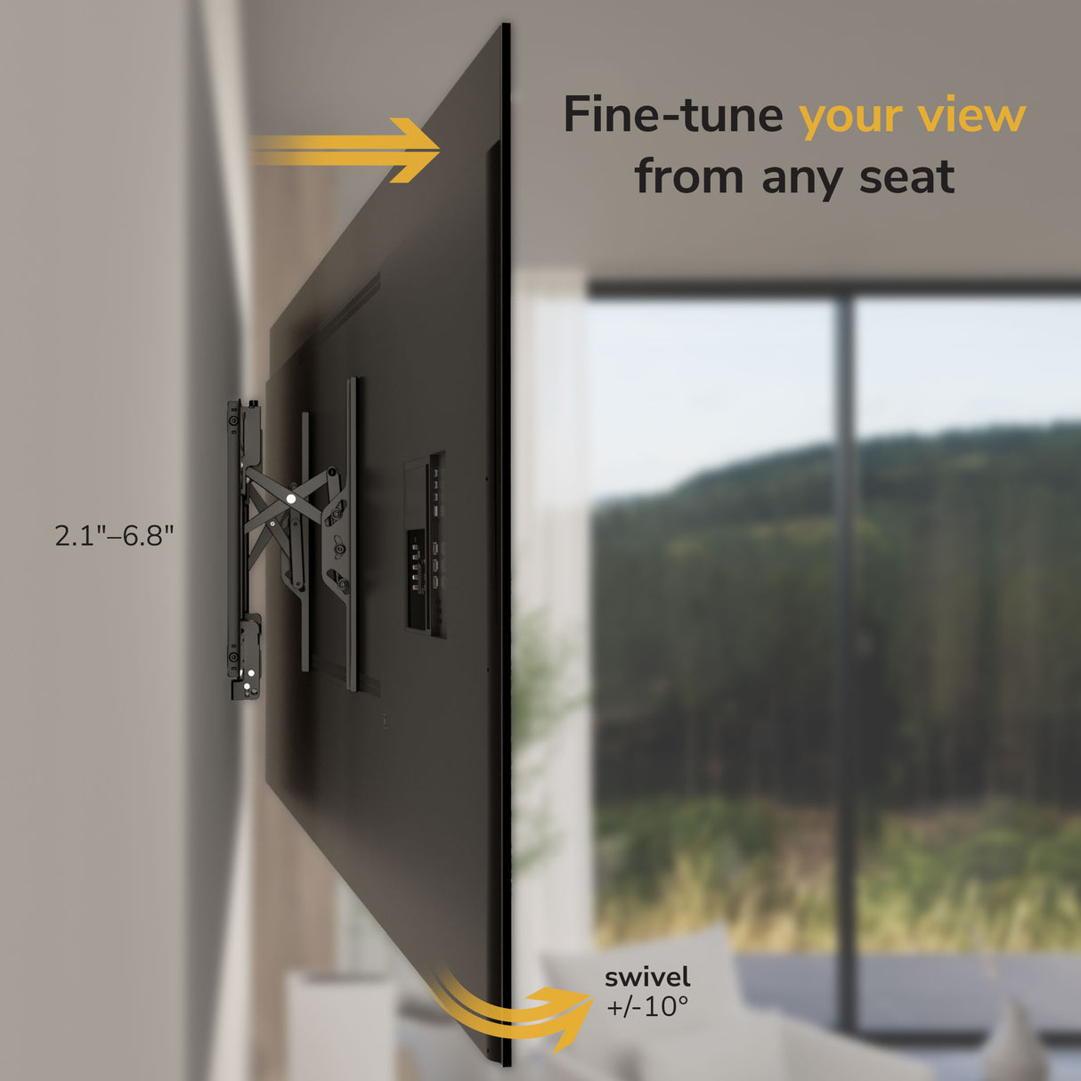 A Mount-It! Heavy-Duty Advanced Tilt TV Wall Mount displays a flat-screen TV on an adjustable bracket, offering 2.1-6.8 inches from the wall and ±10° swivel; blurred windows and greenery appear in the background.