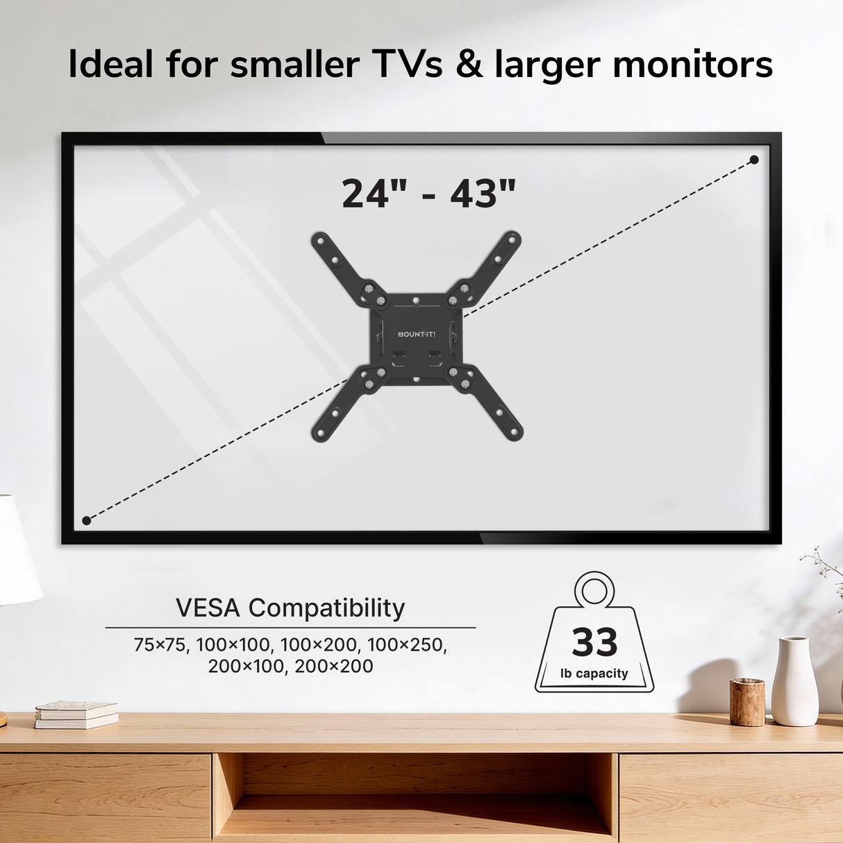 The Mount-It! Low-Profile Tilt TV Wall Mount is attached to a wall in a modern room, holding a 24"-43" TV (up to 33 lbs, various VESA sizes). A shelf with books and a plant is positioned below the mounted TV.