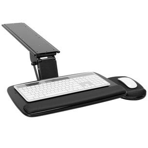 Black adjustable desk setup with keyboard tray, keyboard, mouse, and mouse pad on a white background Black adjustable desk setup with keyboard tray, keyboard, mouse, and mouse pad on a white background