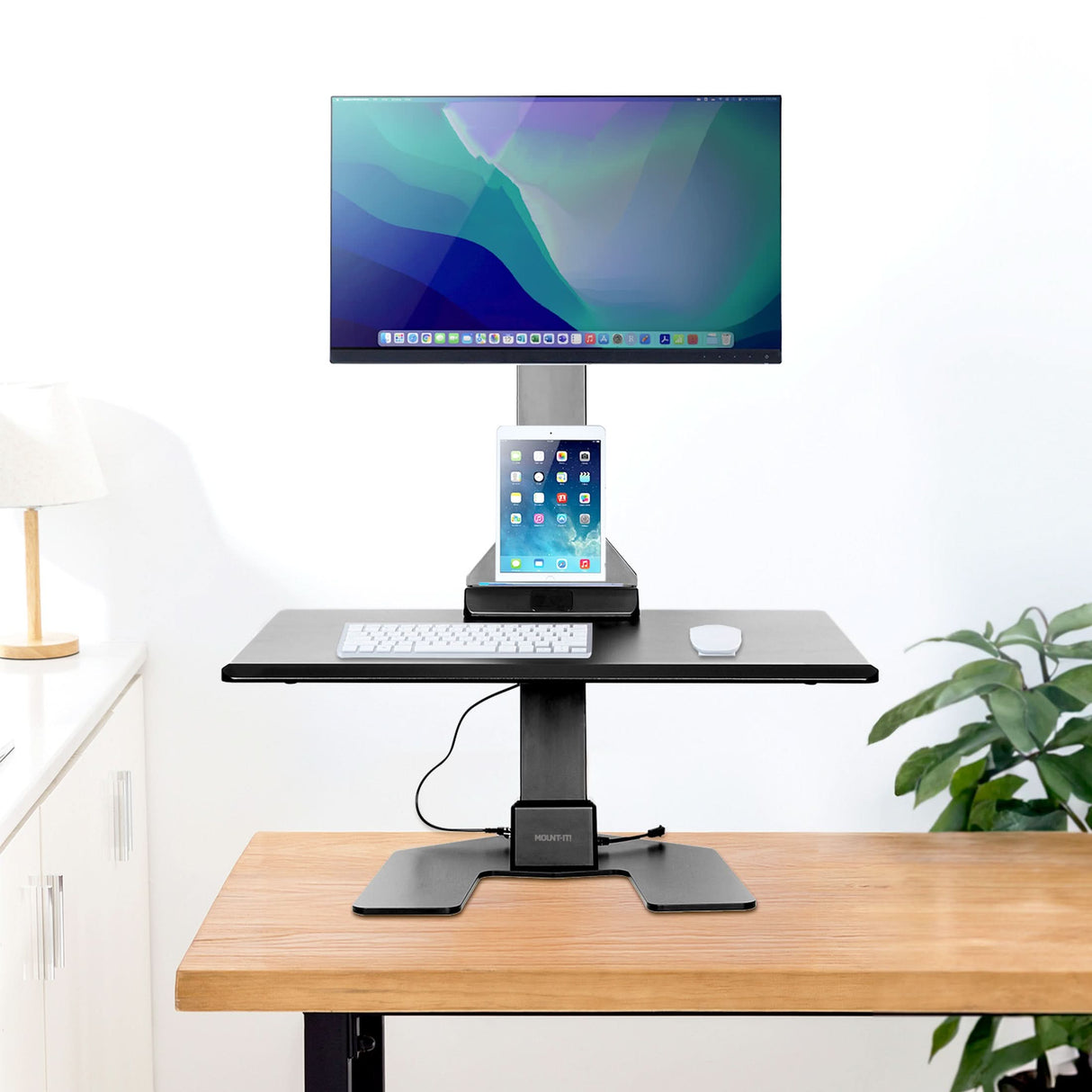 Electric Standing Desk Converter for 1 Monitor Adjustable standing desk converter with computer monitor and tablet on a wood desk and white background