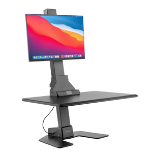 Black adjustable standing desk converter with a monitor on a white background Black adjustable standing desk converter with a monitor on a white background