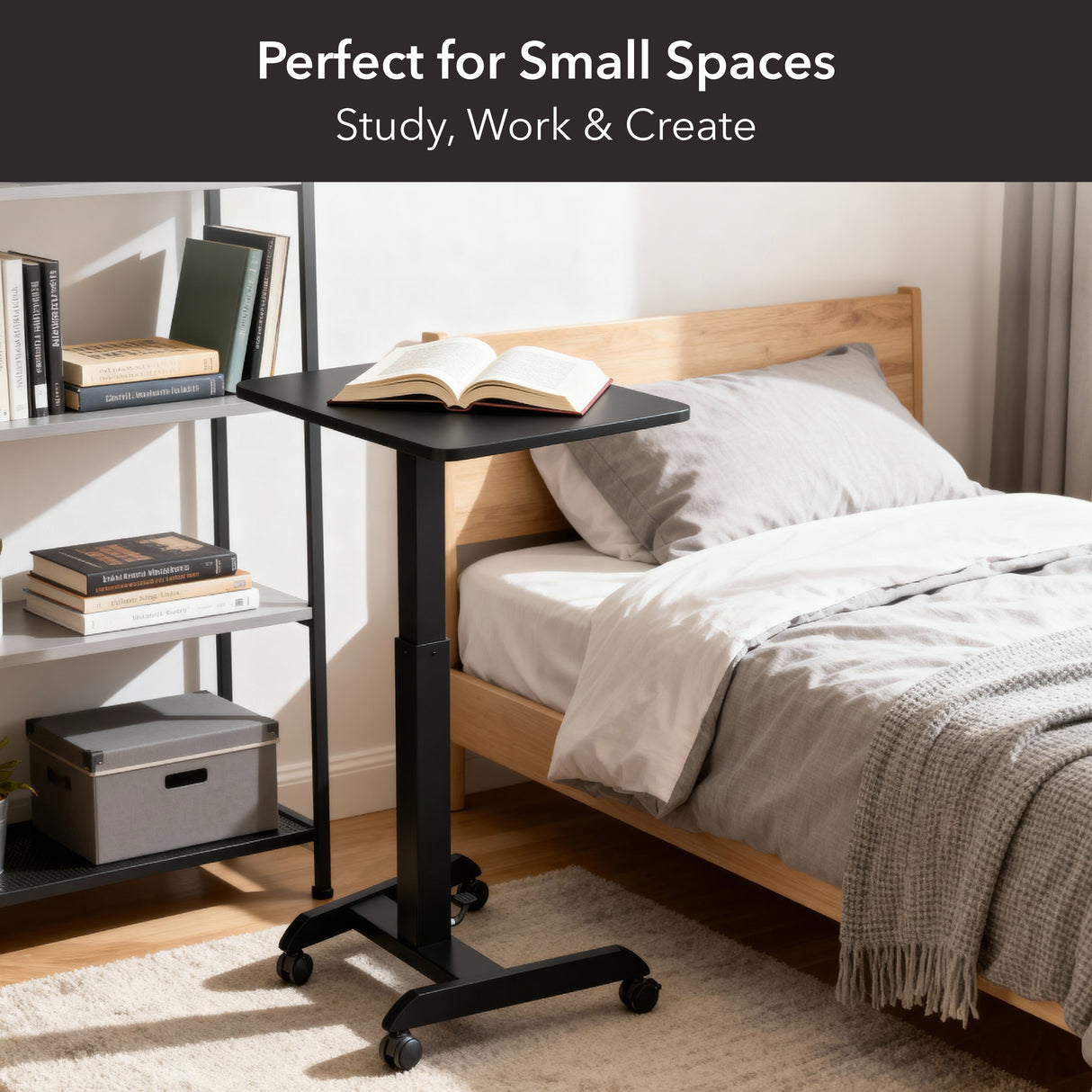 The Mount-It! Height Adjustable Rolling Laptop Desk sits beside a tidy bed in a modern, minimal room, holding an open book. Text above reads: Perfect for Small Spaces – Study, Work & Create.