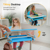 A young girl uses the Mount-It! Kids Desk and Chair Set for Ages 3-10, featuring a blue, height-adjustable desk with a tilting top set to 40 degrees by an adult. An inset shows another girl reading at the desk, highlighting its smooth pull-out storage drawer.