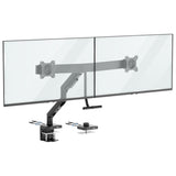 The Mount-It! Dual Monitor Mount with Gas Spring Arm and Crossbar in black securely clamps to your desk, supporting two large flat-screen monitors side by side for a tidy, adjustable dual monitor setup.