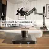 The Mount-It! Laptop Mount with Pole and Gas Spring Arm securely holds a tablet above a desk in a modern office. Inset highlights the base's USB-C and USB-A ports for convenient charging and data transfer.