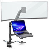 A curved monitor and an open laptop with a blue screen are mounted on the Mount-It! Heavy-Duty Monitor and Laptop Mount, featuring black gas spring arms and a pole, clamped to the desk edge.
