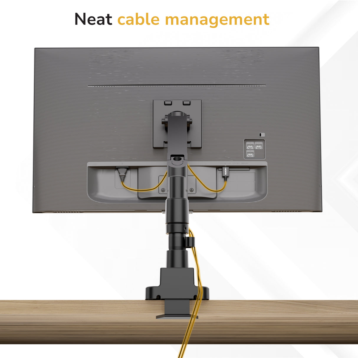 A Mount-It! Heavy-Duty Monitor Mount with Gas Spring Arm is desk-mounted, with cables neatly routed through its built-in cable management. Text at the top reads: Neat cable management.