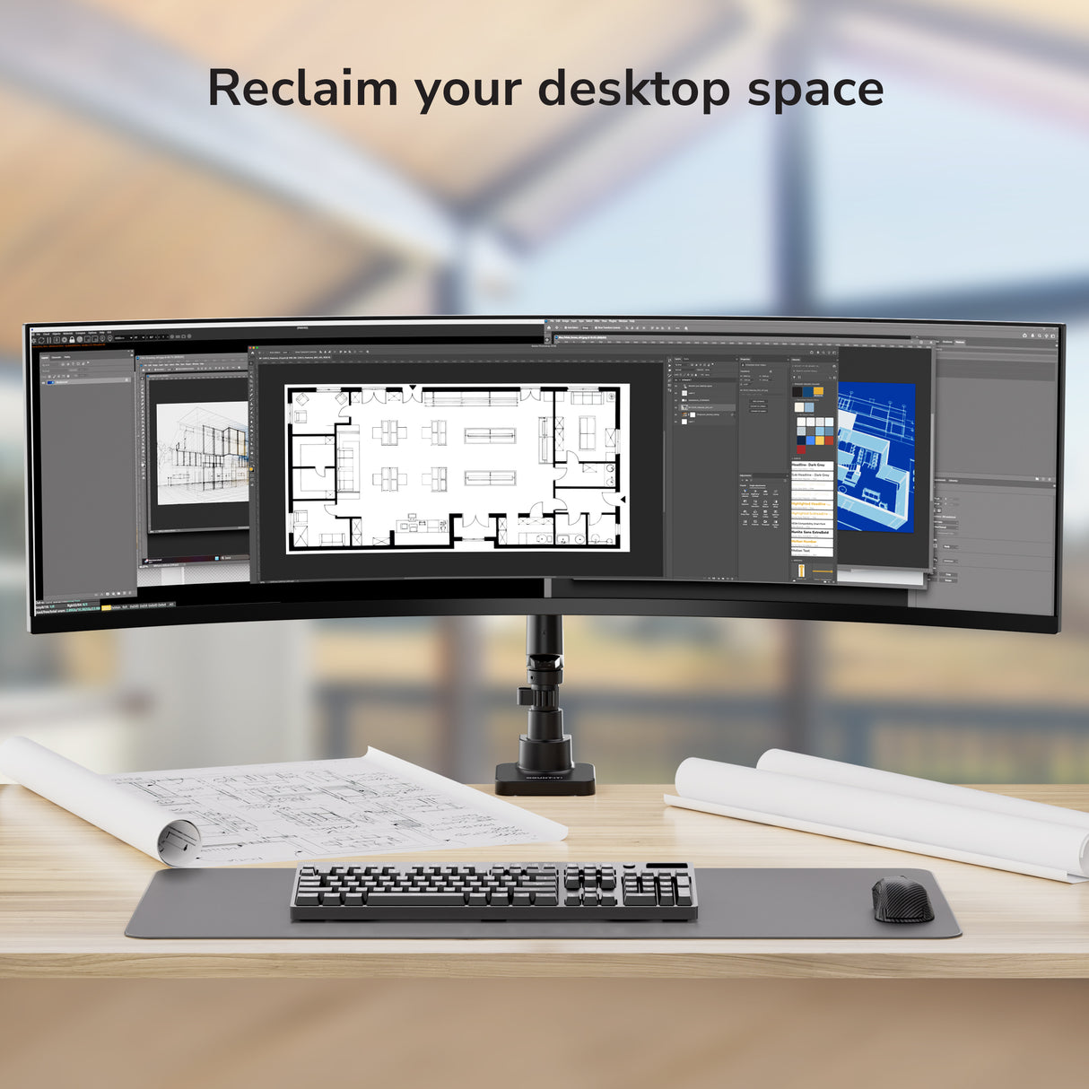 A tidy desk with a keyboard, mouse, and rolled blueprints showcases the Mount-It! Heavy-Duty Monitor Mount with Gas Spring Arm, displaying architectural designs on an ultrawide screen. Text above reads: Reclaim your desktop space.