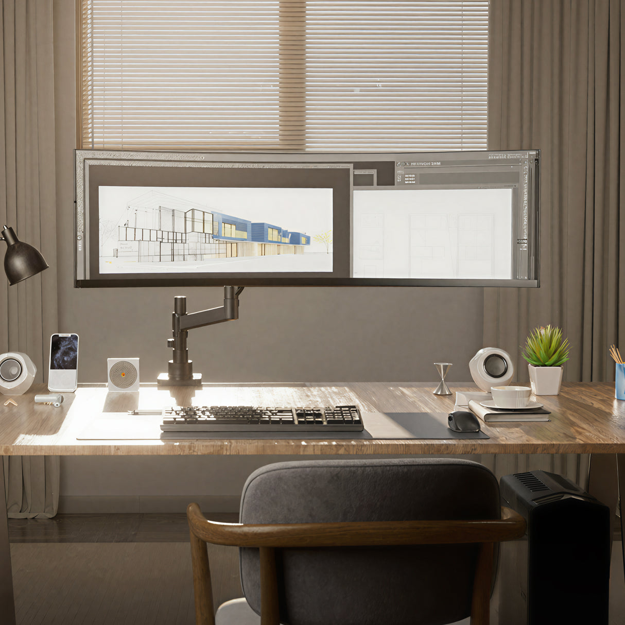 A modern workspace features a large curved monitor on the Mount-It! Heavy-Duty Monitor Mount with Gas Spring Arm, along with a keyboard, mouse, lamp, plant, speakers, and smartphone on a sunlit wooden desk by window blinds.