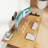 The Mount-It! Heavy-Duty Single Monitor Wall Mount supports a curved monitor above a wooden desk, maximizing space for an ergonomic setup with a keyboard, mouse, notebook, books, and a large potted plant for greenery.