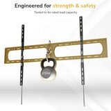 Mount-It! Heavy-Duty XXL Fixed TV Wall Mount holds a 275-pound kettlebell, showcasing its strength. Text above reads: Engineered for strength & safety. Tested to 4x rated load capacity. White background with subtle geometric lines.