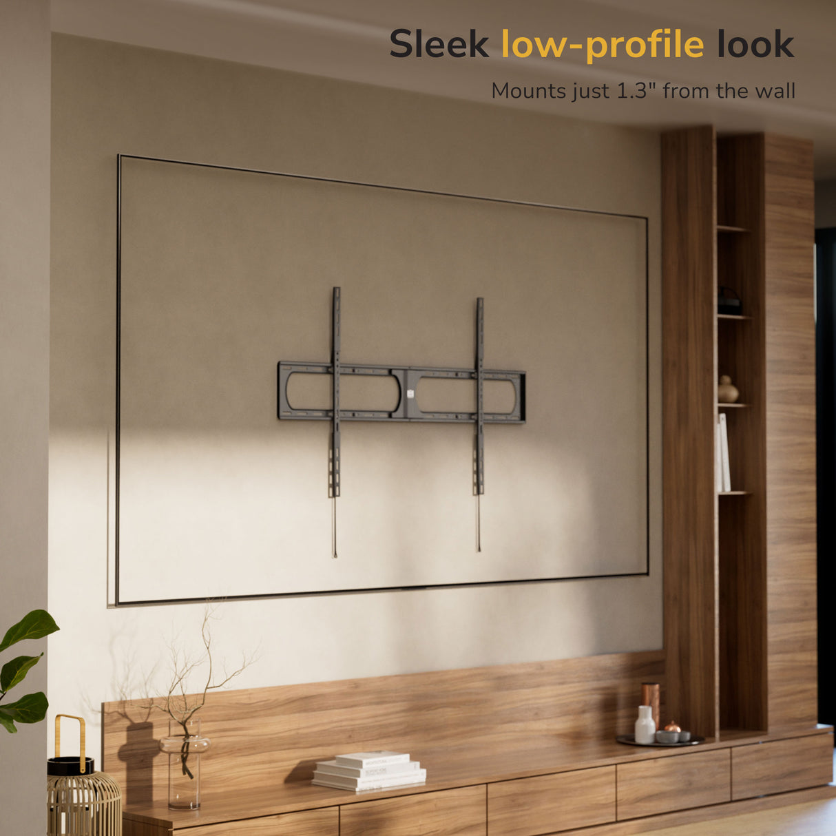 A modern living room features the Mount-It! Heavy-Duty XXL Fixed TV Wall Mount installed above a wooden cabinet. The empty mount sits just 1.3" from the wall, offering a sleek low-profile look.