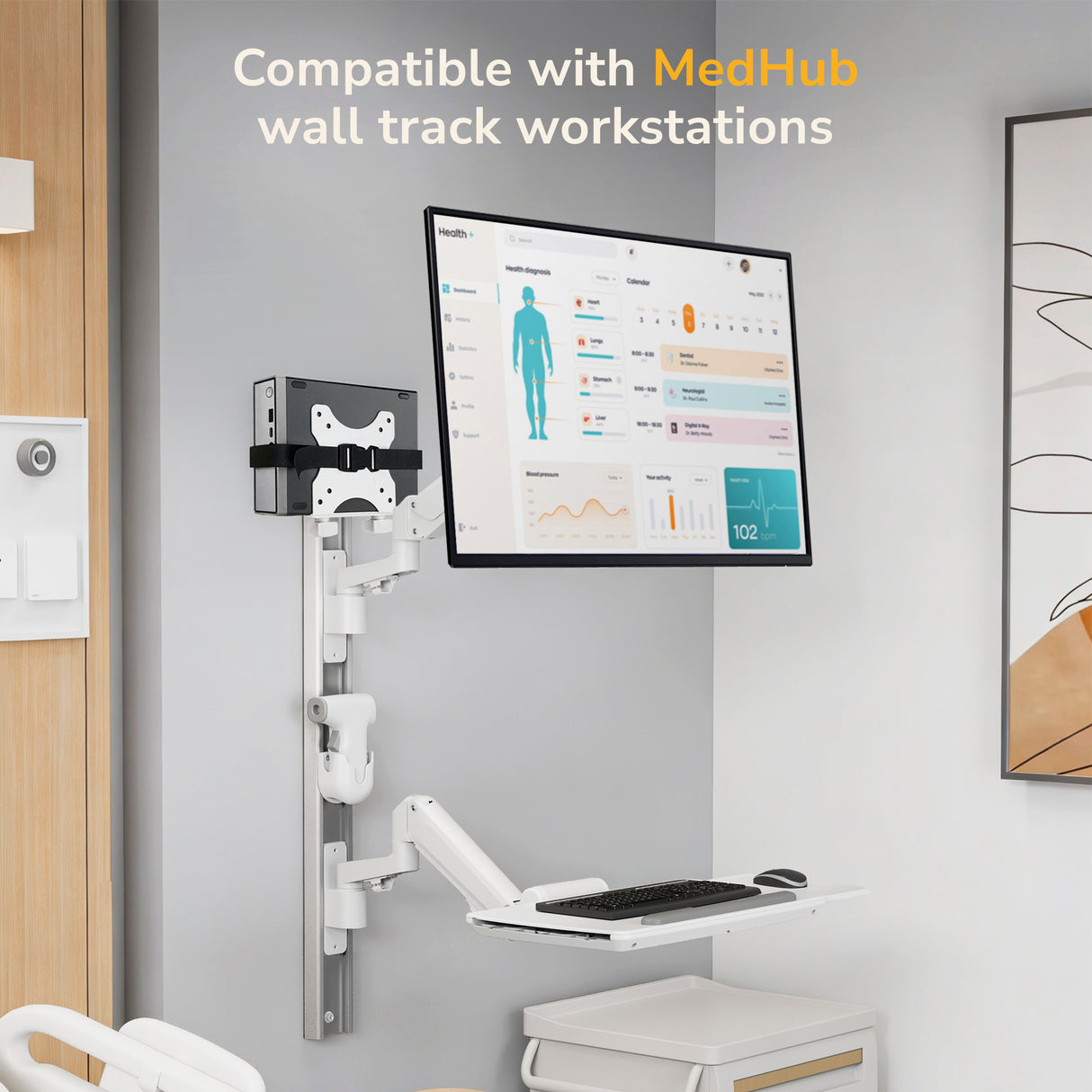 A modern room features a wall-mounted workstation with a large screen showing health data, keyboard tray, mouse, and the Mount-It! MedHub Mini CPU Holder. Text: Compatible with MedHub wall track workstations.