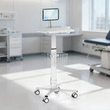The Mount-It! MedHub Mobile Cart with Tablet Mount, featuring a wire basket and wheels, stands in a bright exam room with modern medical equipment and an exam table in the background.