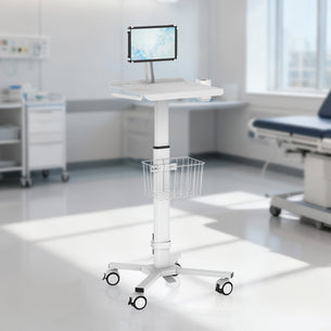 The Mount-It! MedHub Mobile Cart with Tablet Mount, featuring a wire basket and wheels, stands in a bright exam room with modern medical equipment and an exam table in the background.