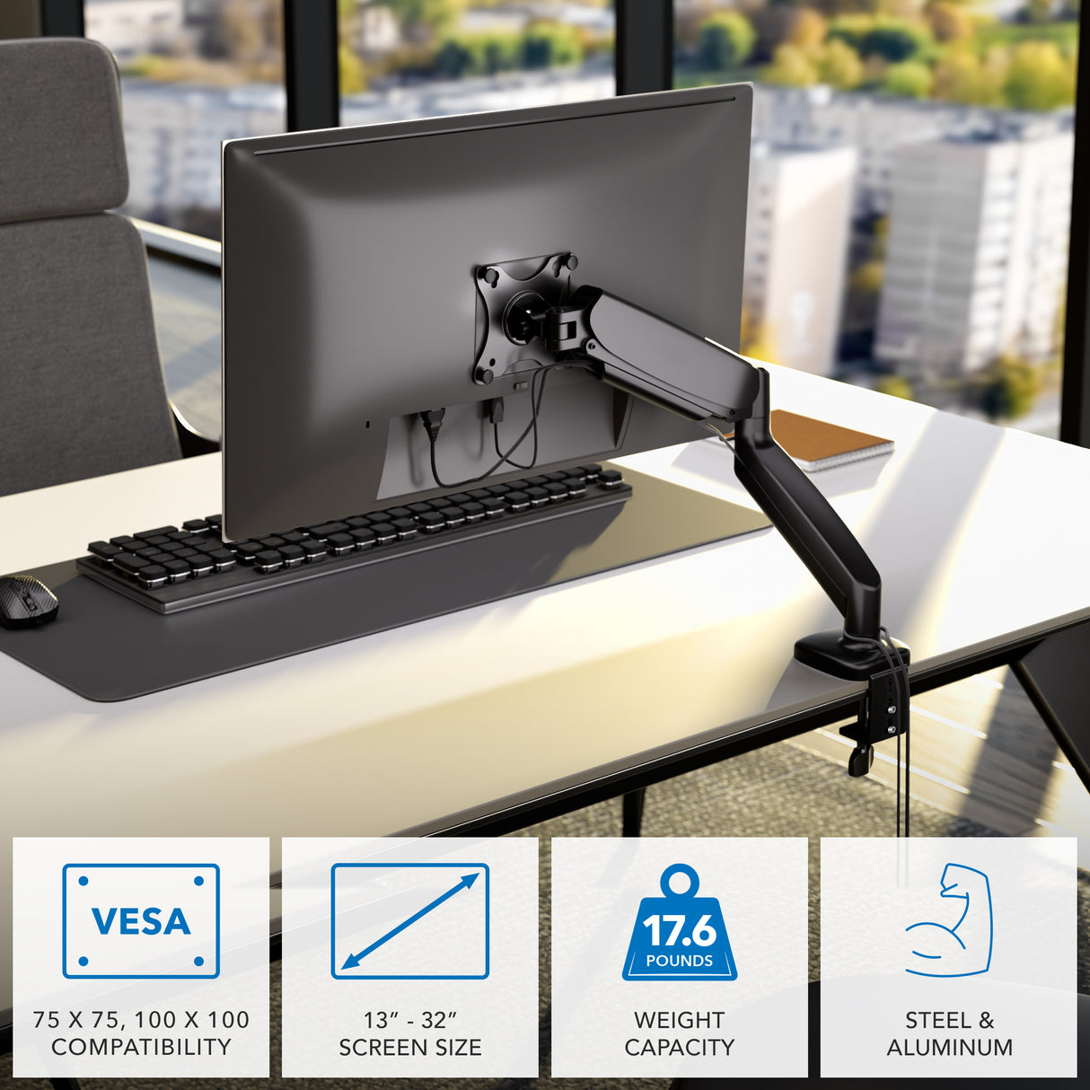 A Mount-It! Single Monitor Desk Mount with Gas Spring Arm holds a computer monitor beside a window, offering height adjustment, ergonomic design, cable management, VESA support, fits 13–32" screens up to 17.6 lb; made of steel & aluminum.