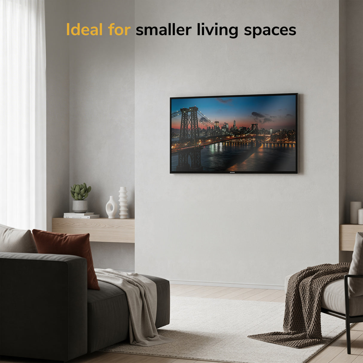 Modern living room with a Mount-It! Low-Profile TV Wall Mount displaying cityscape at sunset, cozy gray sofa, light curtains, and minimalist decor. Top text: Ideal for smaller living spaces.