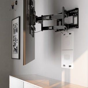 A flat-screen TV is mounted above a wooden cabinet using the Mount-It! In-Wall Media Box - Large, with a black-and-white framed photo on the adjacent gray wall and a media device organizer below.