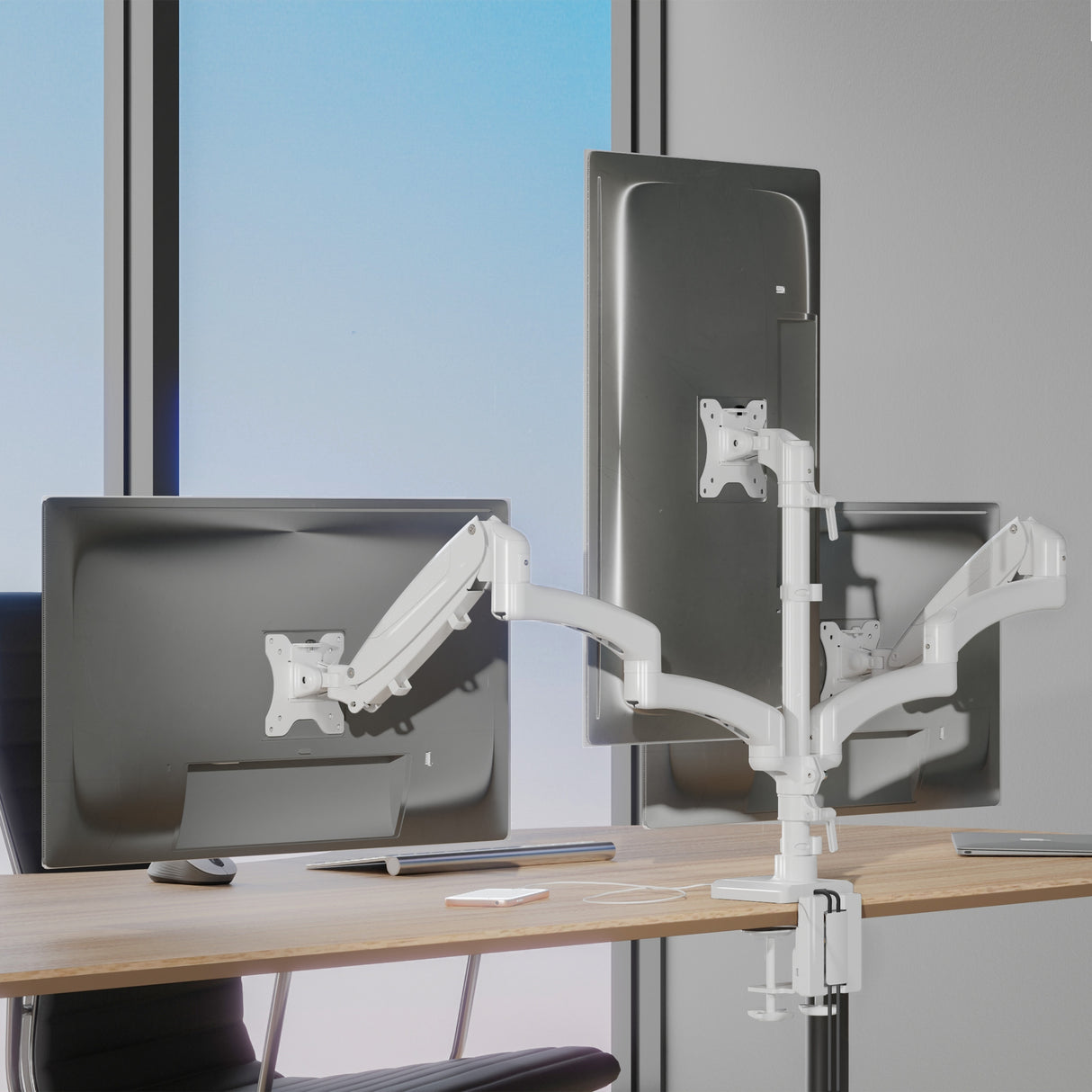 Triple Monitor Mount with Gas Spring Arms and USB Ports mounted on a desk, showcasing three adjustable screens held by white aluminum arms with gas spring mechanism, allowing tilt, swivel, and rotation for ergonomic positioning, with a clean workspace and natural light in the background, designed for productivity enhancement in professional or creative environments.