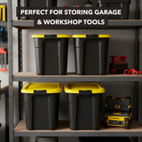 Four Mount-It! Heavy-Duty Storage Bins with yellow lids are neatly arranged on shelves in a garage, surrounded by tools. Text above: Perfect containers for organizing garage or workshop gear.