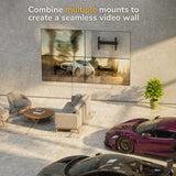 A modern living room features two luxury cars, a seating area, and a large split-image video wall. The text reads: Combine multiple Mount-It! Pop-Out Video Wall Mounts for heavy-duty support and a seamless display.