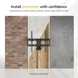 The Mount-It! Full Motion Corner TV Wall Mount attaches to brick, wood studs, and concrete. Top text: Install anywhere with confidence. Bottom text: Hardware included.