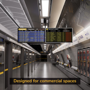 A modern, empty subway station features Mount-It! Dual TV Ceiling Mount with Short Pole suspending digital departure boards. Ticket machines line the wall. Text overlay at the bottom reads, Designed for commercial installations.