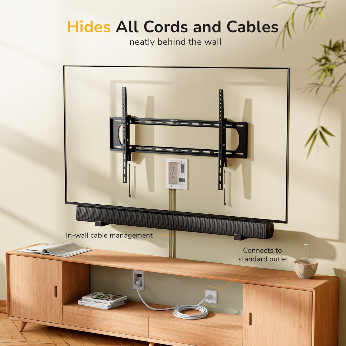 A wall-mounted TV sits above a wooden console and soundbar. The Mount-It! In-Wall Cable Management Kit with USB and Power Input Module neatly hides cables behind the wall, exiting at a recessed power outlet near the console.
