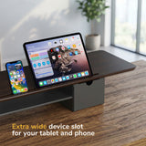 The Mount-It! Extra Wide Monitor Riser with Drawers and Shelf features a spacious slot to hold your tablet and phone side by side on your desk.