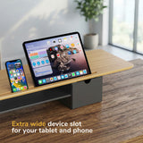 The Mount-It! Extra Wide Monitor Riser with Drawers and Shelf features a spacious device slot to hold your tablet and phone side by side—a perfect organizer for your ergonomic workspace.