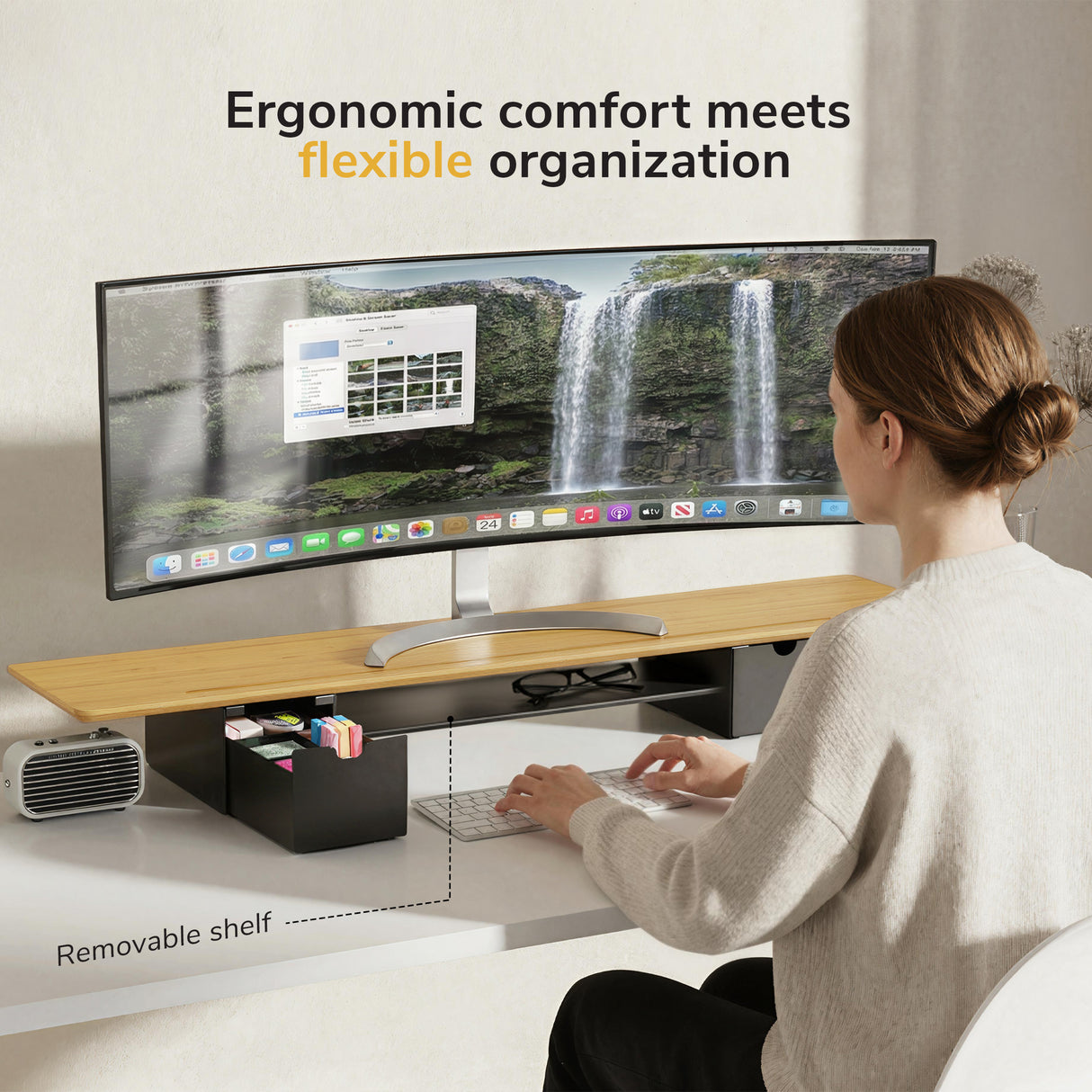 A woman uses the Mount-It! Extra Wide Monitor Riser with Drawers and Shelf at her desk, neatly organizing office items below. Text above: Ergonomic comfort meets flexible organization.