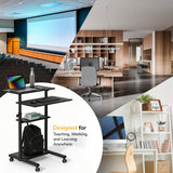 A Mount-It! Height Adjustable Rolling Stand up Desk with locking casters holds a laptop, water bottle, keyboard, and backpack before images of a lecture hall, modern office, and home workspace. Text: Designed for Teaching, Working & Learning Anywhere.