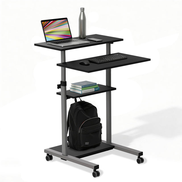 The Mount-It! Height Adjustable Rolling Stand up Desk in black features locking casters, a modern compact design, and easy mobility. It holds a laptop, water bottle, keyboard, mouse, three books, and has a lower shelf for a black backpack.