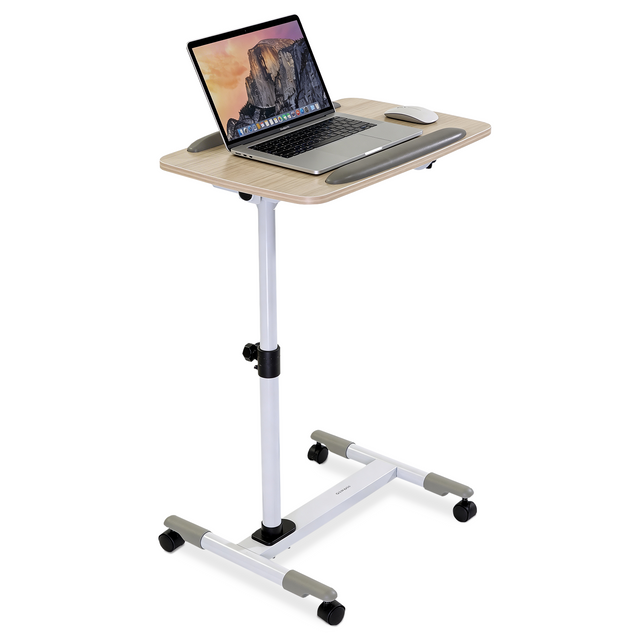 The Mount-It! Height Adjustable Rolling Laptop Cart in white features a wood finish top, silver legs, and four caster wheels—perfect as an over-bed laptop tray or mobile workstation. A laptop and mouse sit on the tabletop for easy access.