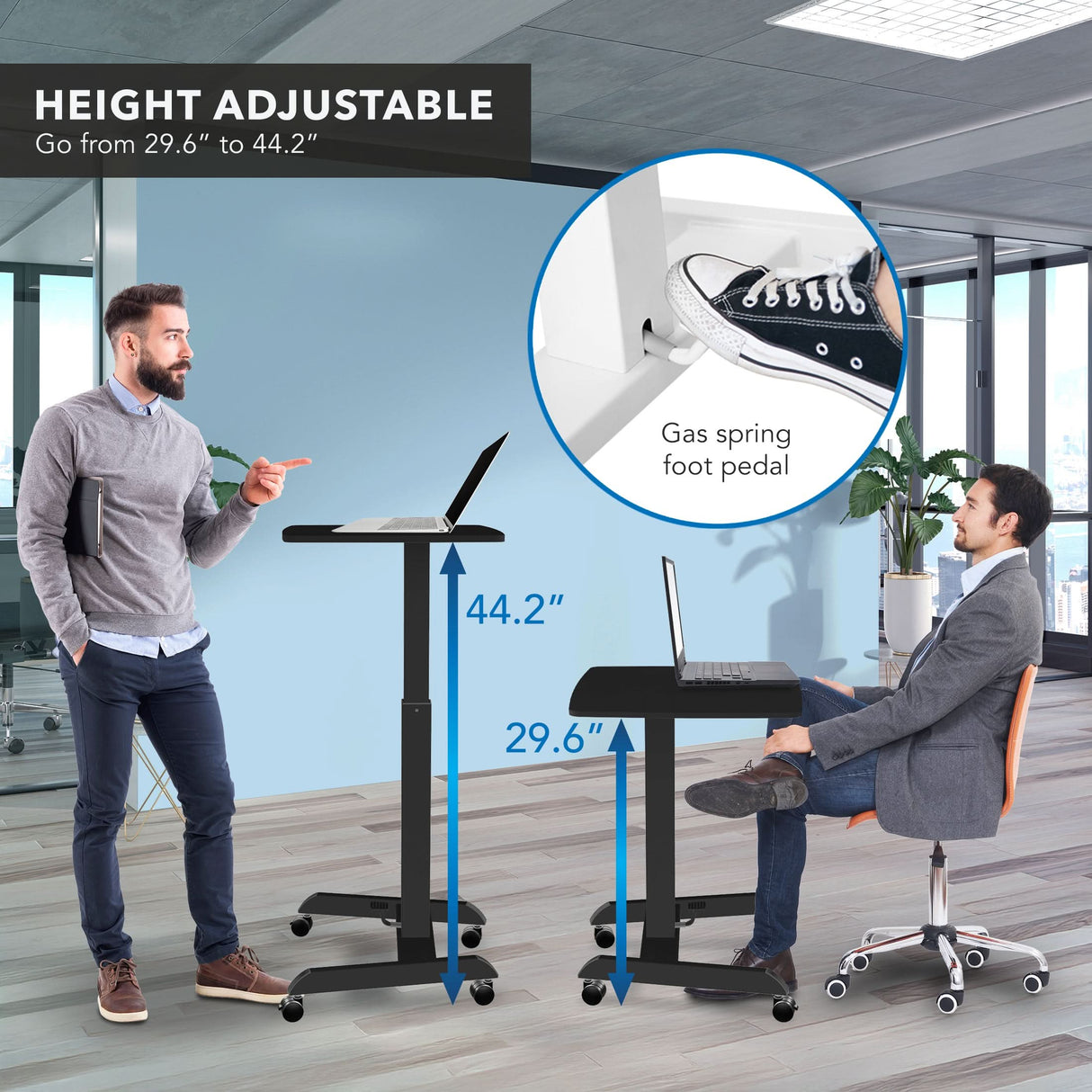Two men in an office use the Mount-It! Height Adjustable Rolling Laptop Desk—one sitting, one standing—to demonstrate its ergonomic design. An inset shows a foot pressing the gas spring pedal to adjust height from 29.6" to 44.2".