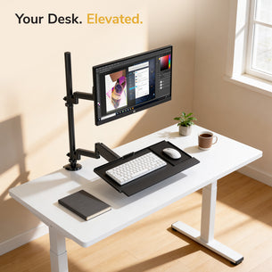 A modern white desk features the Mount-It! Single Monitor Sit-Stand Desk Mount with Keyboard Tray, complete with a mouse, notebook, plant, and coffee cup. Sunlight streams in as “Your Desk. Elevated.” appears at the top left.