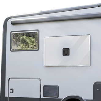Side view of a light gray camper van showing a window, a closed external storage compartment, and part of a wheel well, with trees reflected in the window.