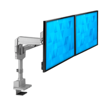 A dual monitor setup mounted on an adjustable silver arm clamp, displaying blue geometric patterns on both screens, with a white background.
